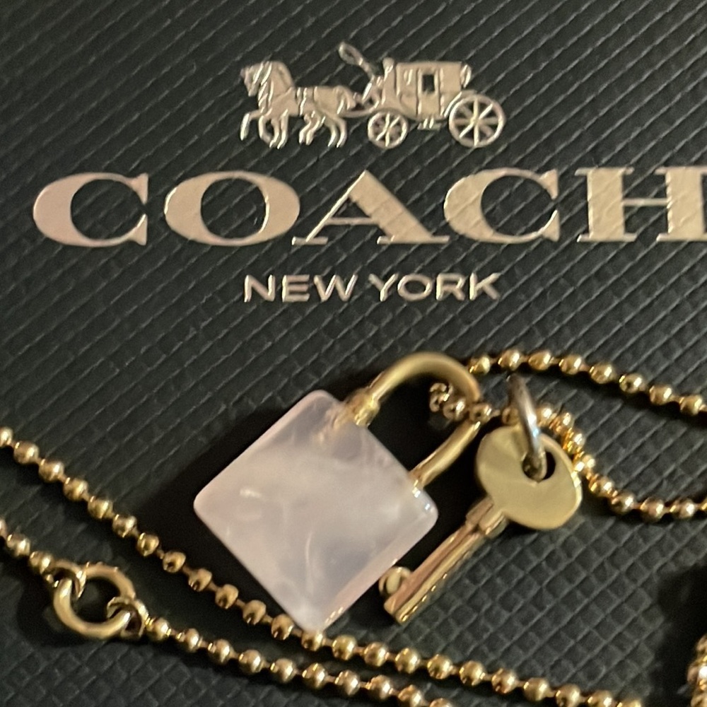Coach pink and gold lock and key necklace.